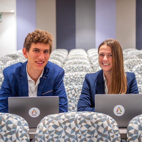 two students with laptops